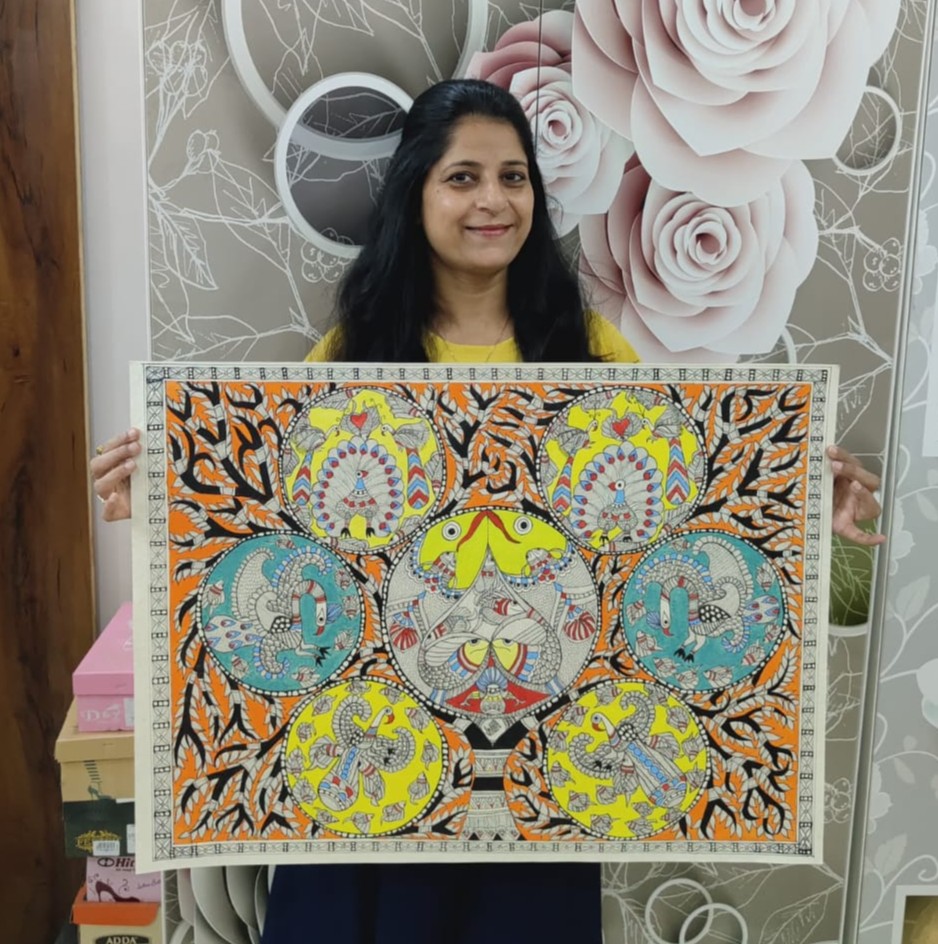 Nitika Goyal holding a handcrafted Madhubani painting